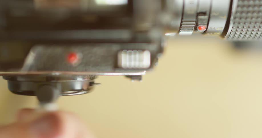 A woman is adjusting a video camera