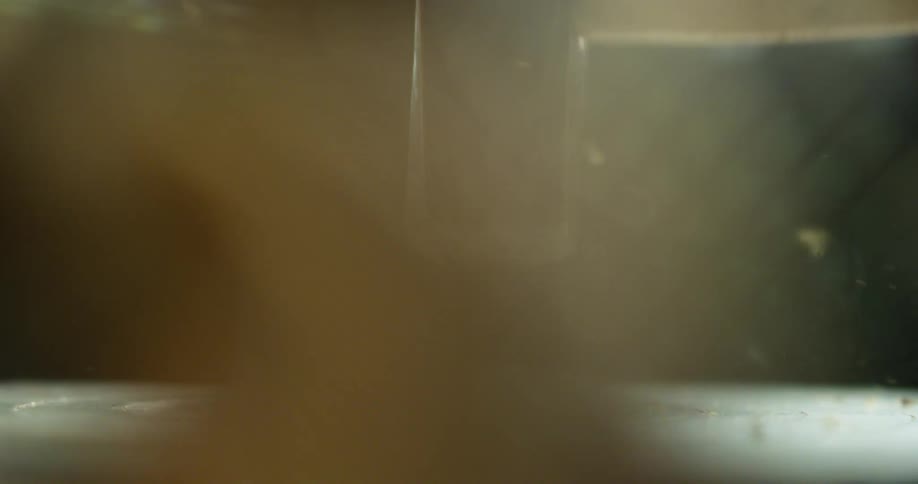 A nut on a spinning surface explodes when hit with a sledgehammer