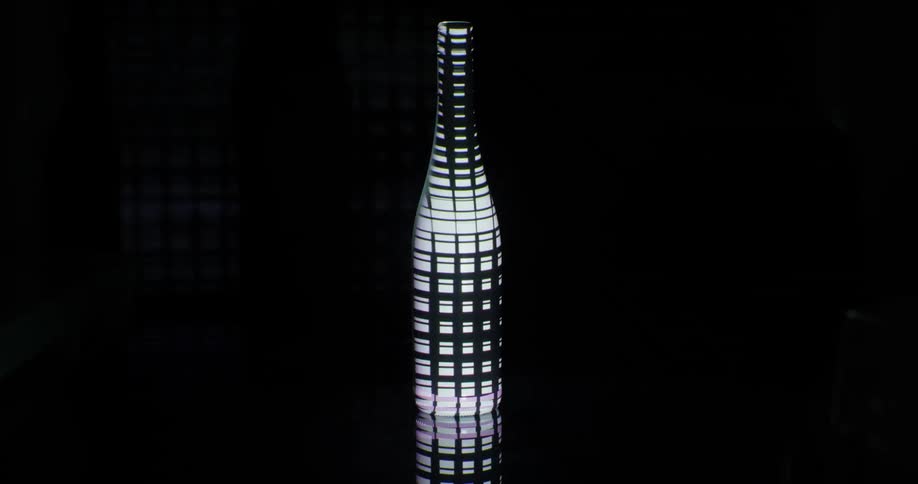Images of a grid being projected on a white bottle