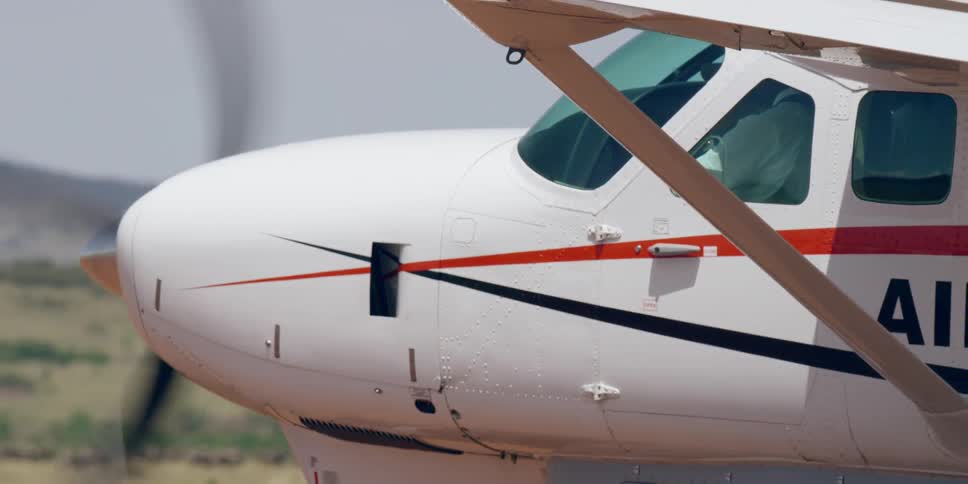 A small airplane drives in a rural area