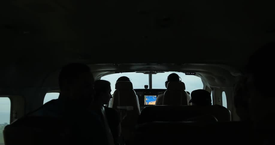 A group of people sit in a plane