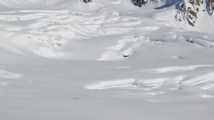The plane flies over the mountains