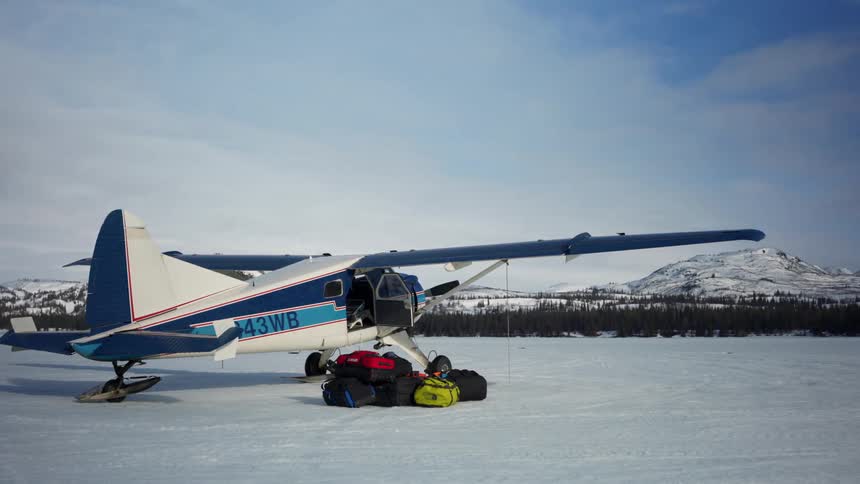 An airplane is parked at an arctic area