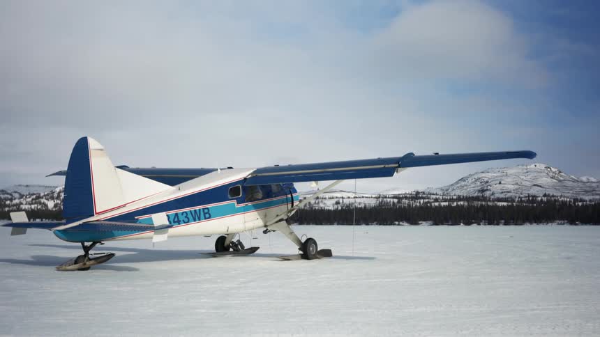 An airplane sits on the snow covered ground
