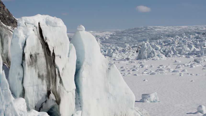 Ice formations and snow cover a winter landscape on a sunny blue sky day