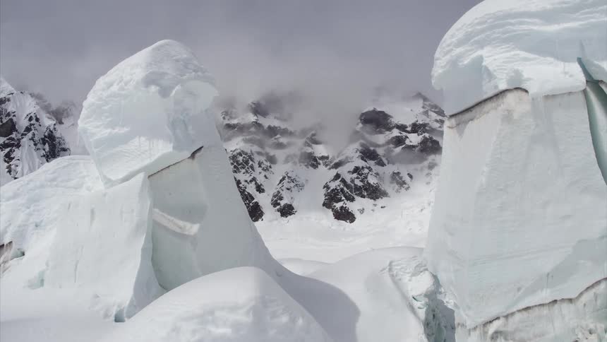 Large ice formations and mountains shrouded in fog in the arctic