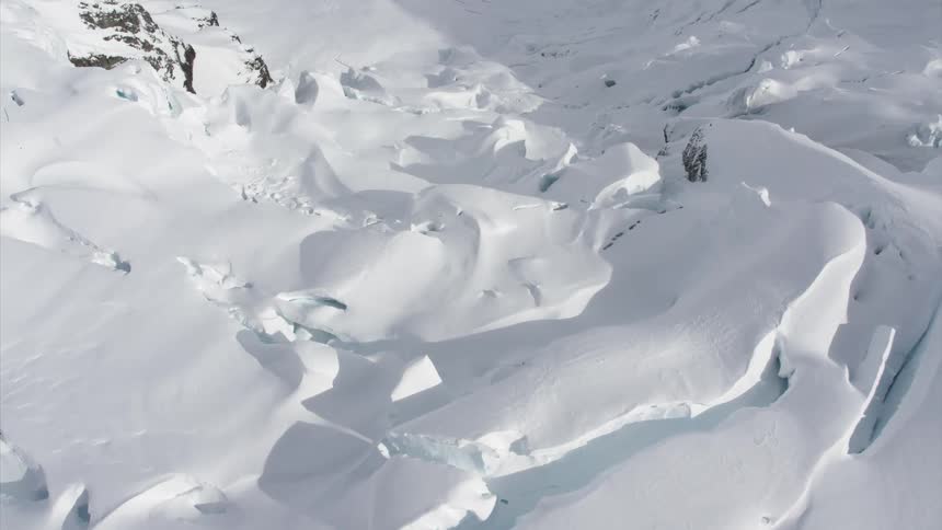 Deep snow covers mountains and rocks