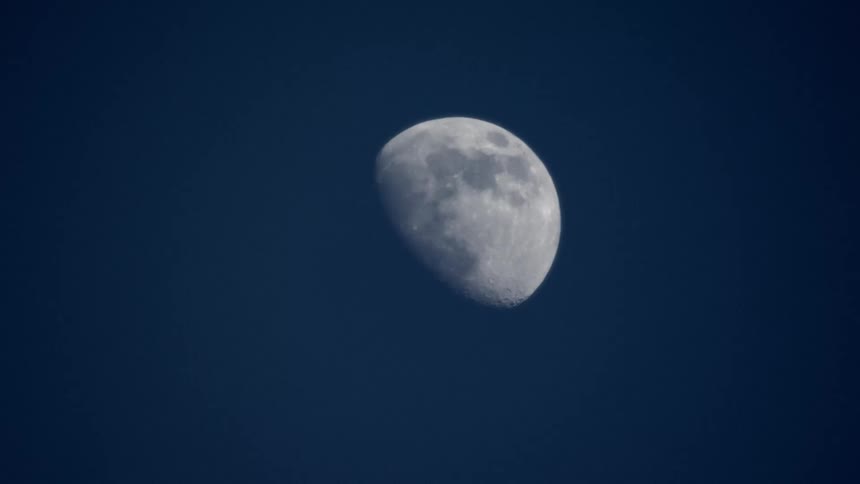 The waxing gibbous moon in the clear night sky