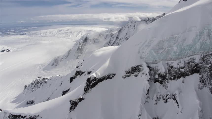 Aerial view of rugged mountain range covered in snow