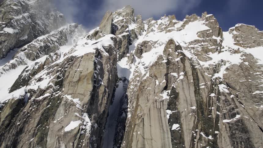 Snow is covering the mountains and cliff