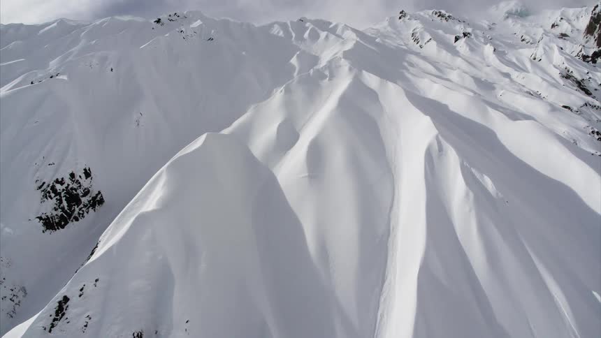 Aerial view of a snow covered mountain range at day