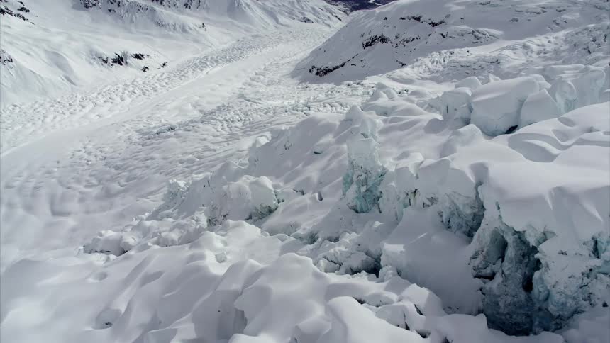 Aerial view of snow covered valley in mountains