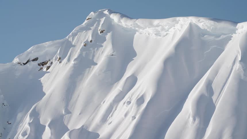 Snow covered peaks of mountain range at day