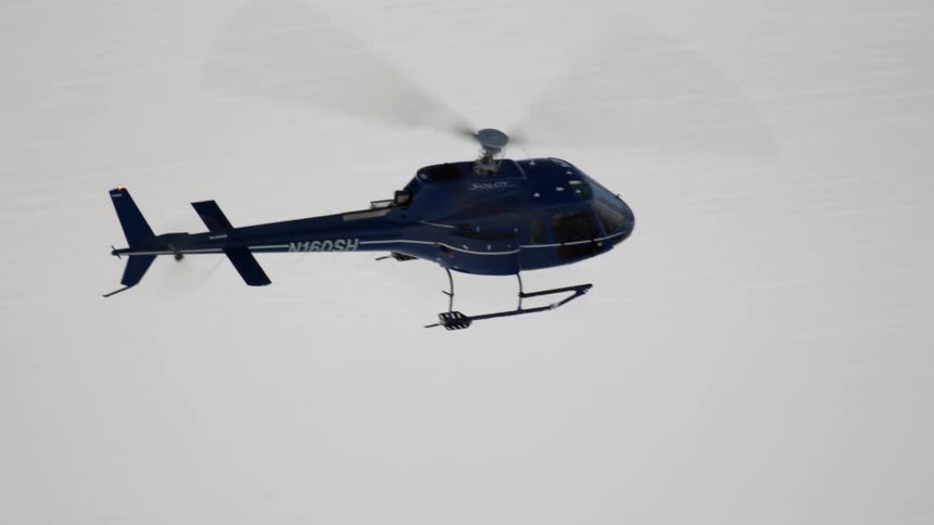 A helicopter is flying in the air
