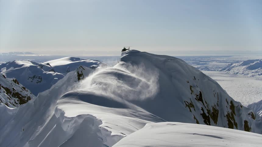 The helicopter spins over the mountain