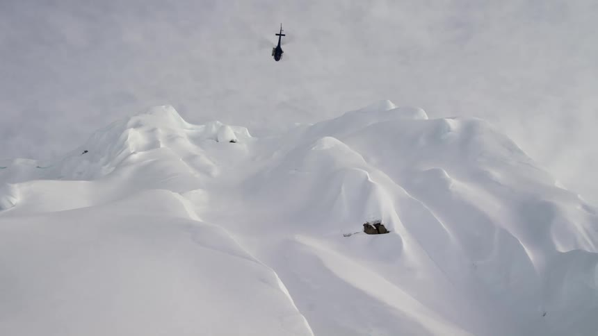 A helicopter flying over a mountain