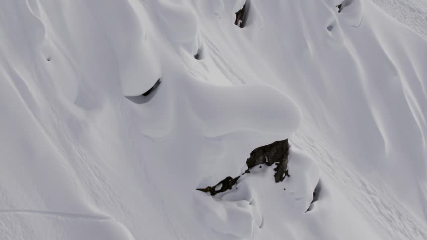 Drifts of snow on a mountain slope look like a human face