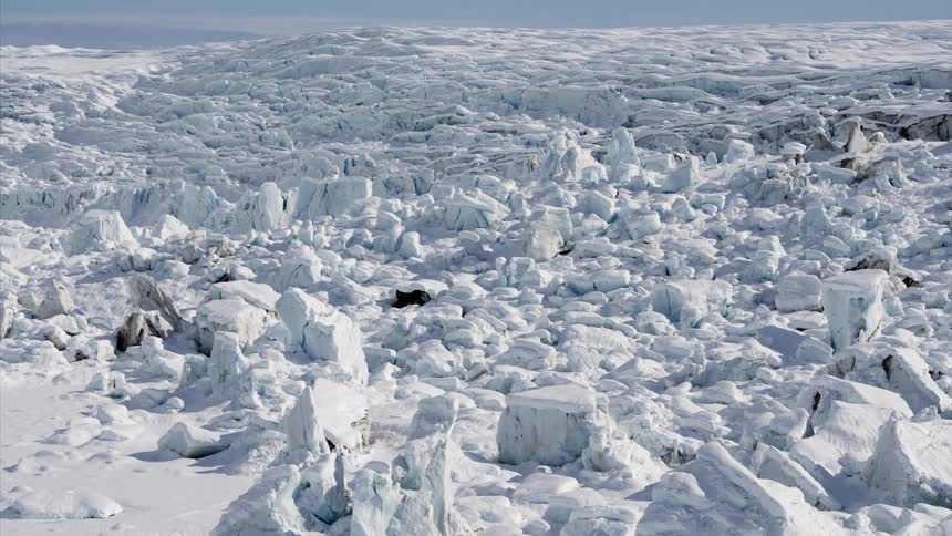 Snow covers the ground in large frozen blocks