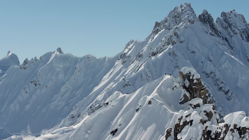 A jagged snow covered mountain ridge on a sunny day