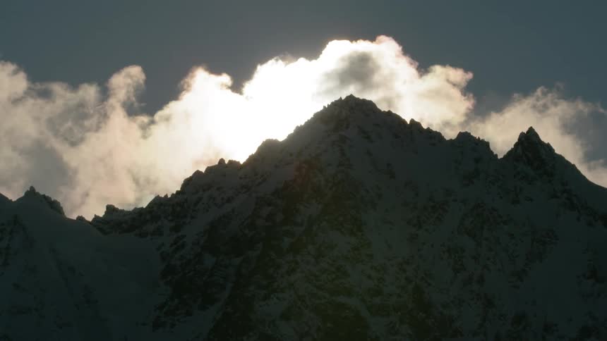 A mountain range is covered with snow in the winter