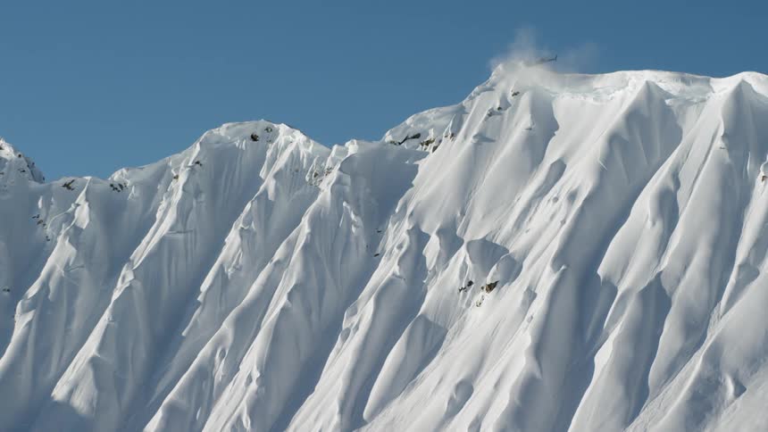 A helicopter is above a mountain range