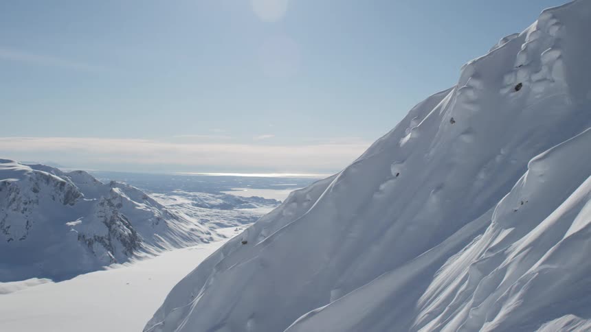Snow covered peaks on a mountain range at day