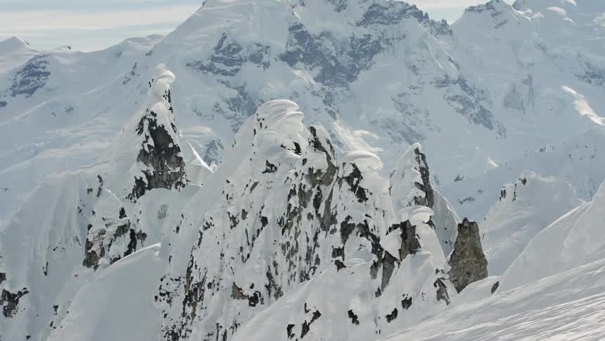 Snow covered peaks of a mountain range at day