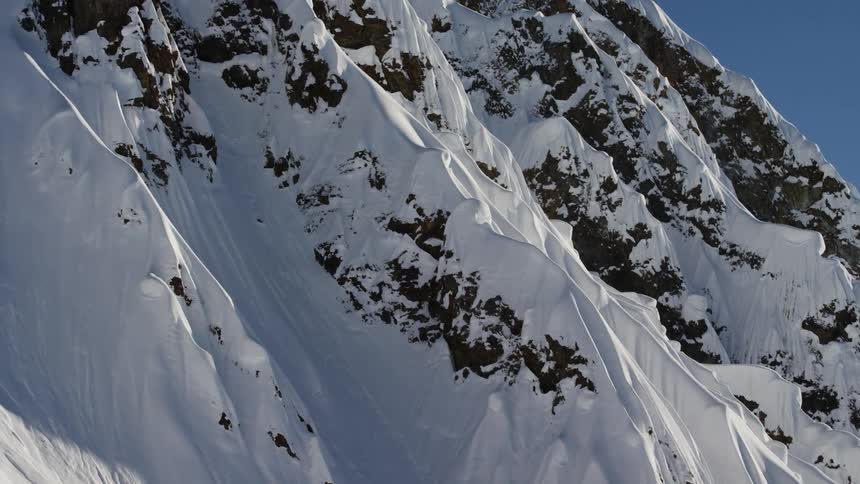 Snow covered mountain peaks at day