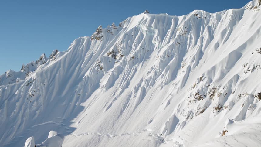 A snow covered mountain under a clear blue sky