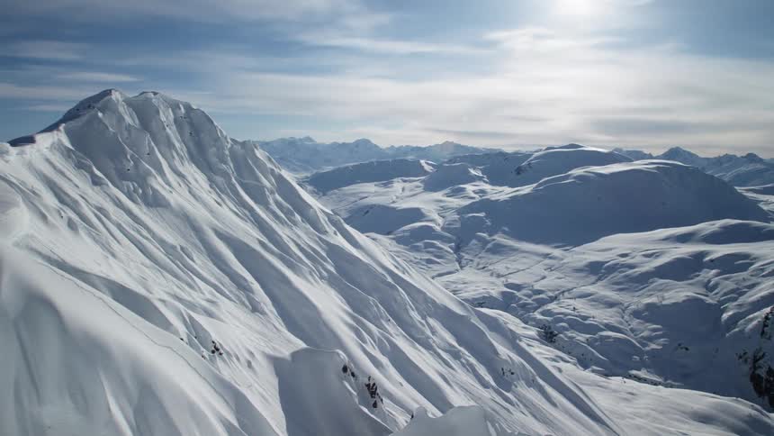 Aerial view of snow capped mountains on a sunny day