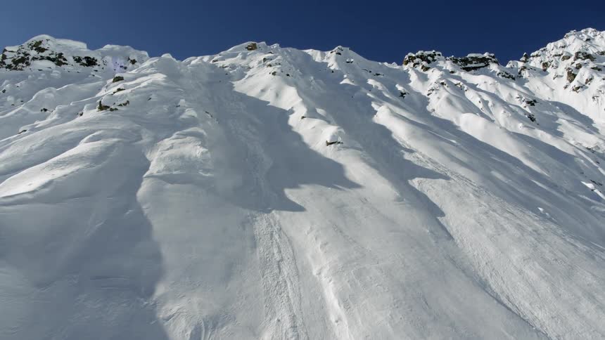 Snow covered mountains under a bright blue sky