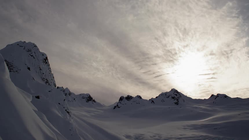 The clouds flow over the mountain range