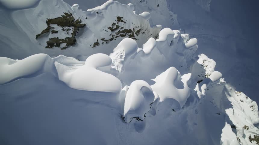The heavy snow covers the ridge of the mountain