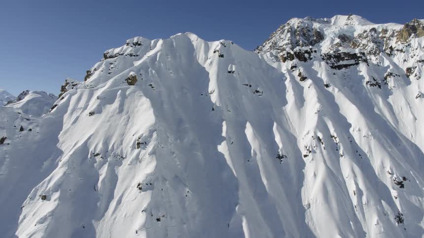 The tall mountain range is covered with snow