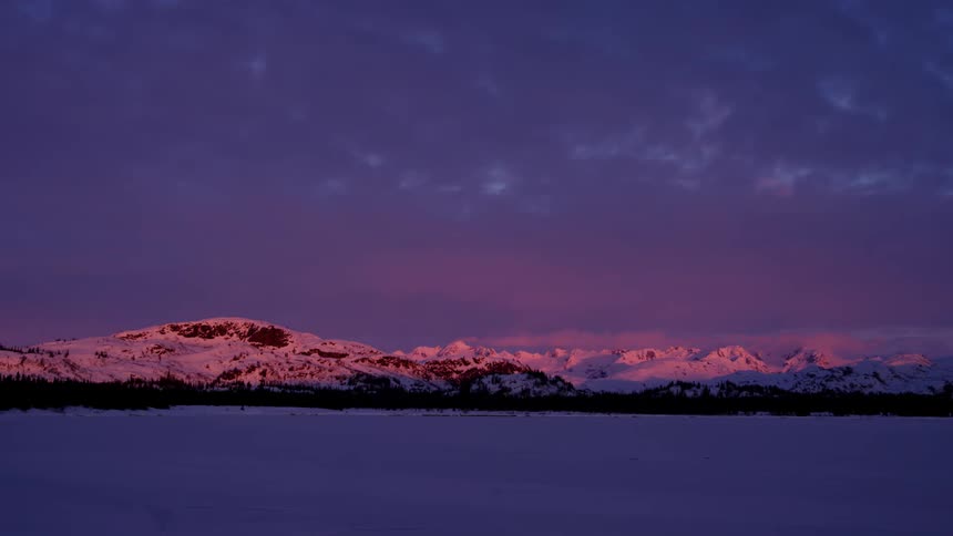 A mountain range covered in snow during the winter