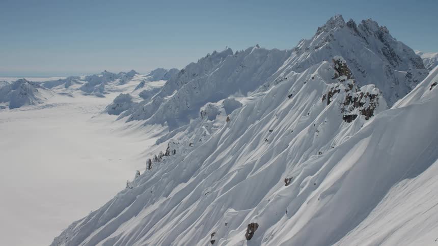 Snow drifts deeply cover the slope of a mountain range