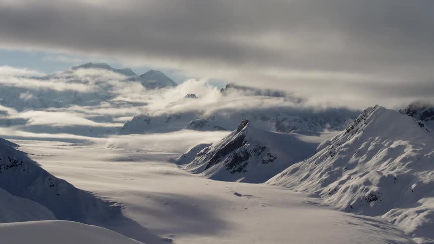 The clouds roll over the mountains