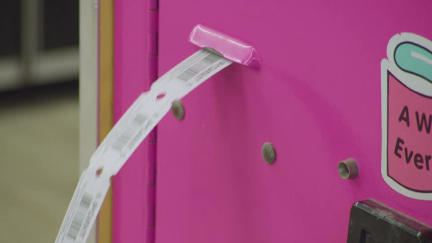 A machine dispenses a number of tickets