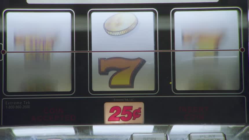A person is playing the slot machine