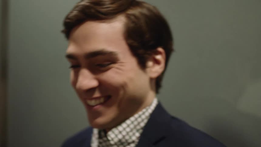 A young man smiles and is very excited