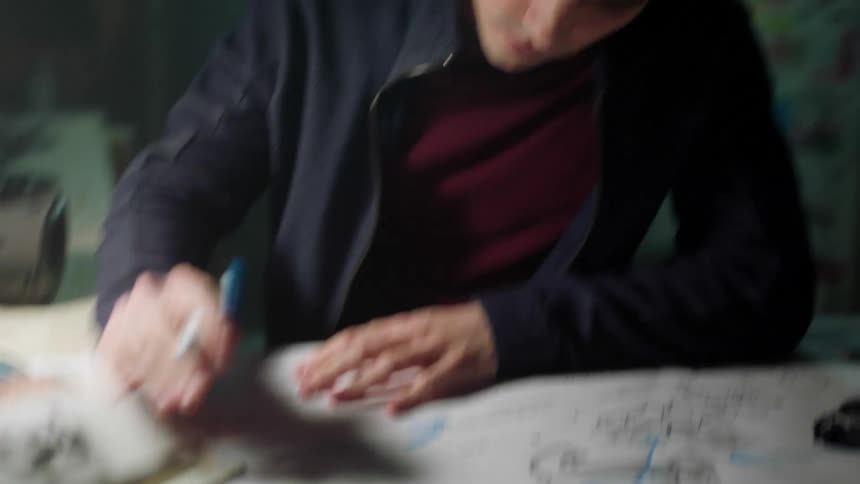 Man studying and working on graphic designs at desk