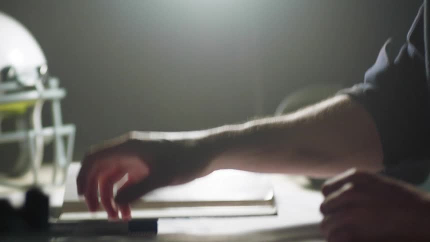 Man sitting at the desk studies in his room