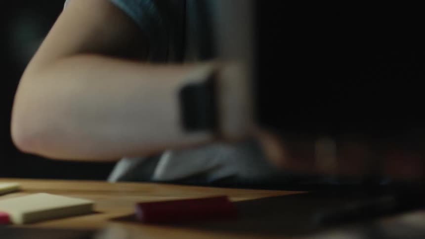 A girl searching for her notebook on a desk