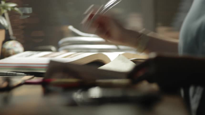 A woman sits at her desk and writes