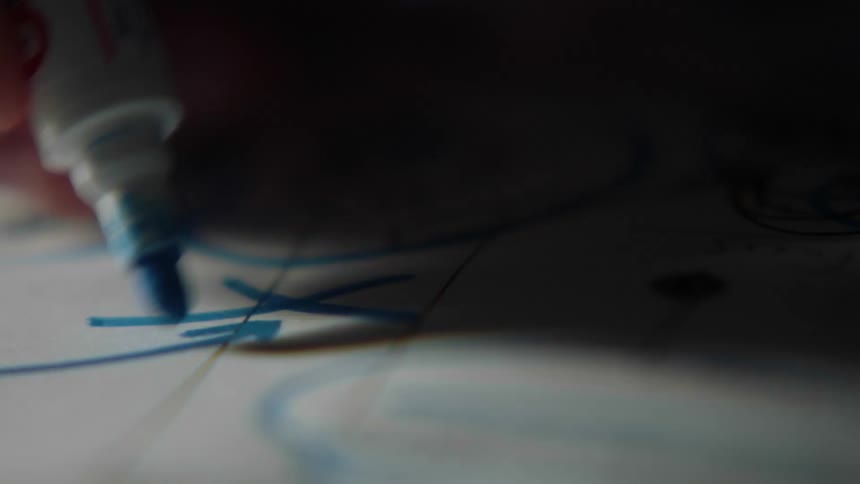 A person is writing on a pad with a marker