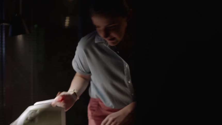 A woman looking at a paper in an office