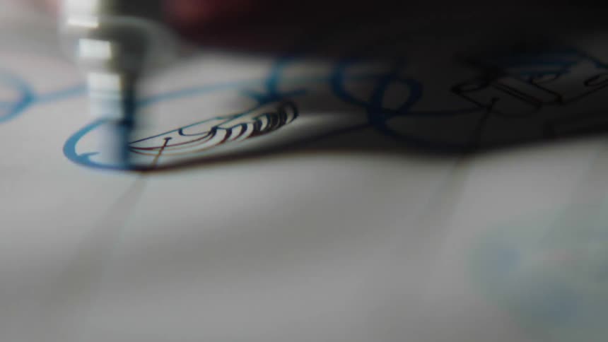 A person is circling drawings on the paper