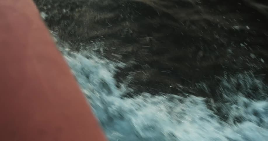 The boat travels through the water giving off waves