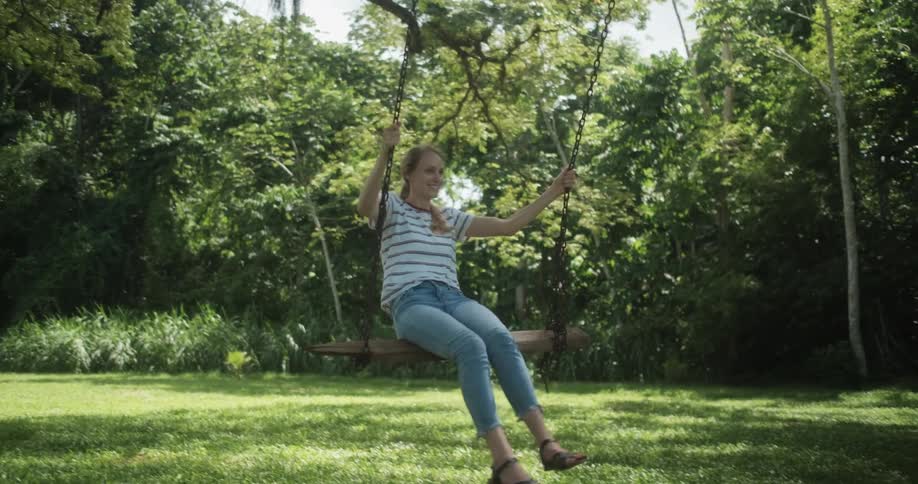 Woman swinging on a tree swing