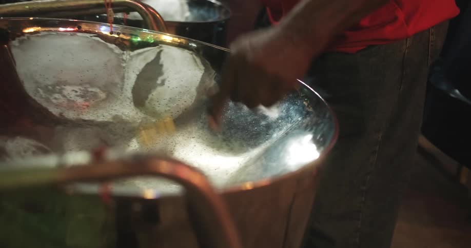 People play the steel drums together